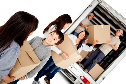 Moving team handling boxes and furniture in a Lisson Grove street