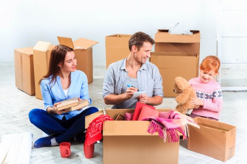 Moving team handling boxes safely outside a property