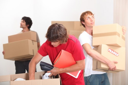 Packed moving boxes and furniture loaded into a van